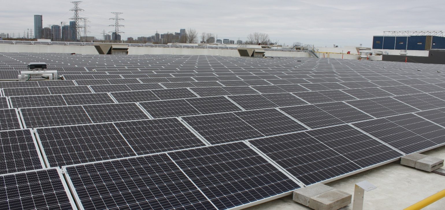 Solar panels installed across the rooftop of a DYMON facility